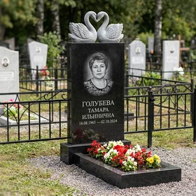 Памятник с парой лебедей из черного габбро-диабаза с портретом